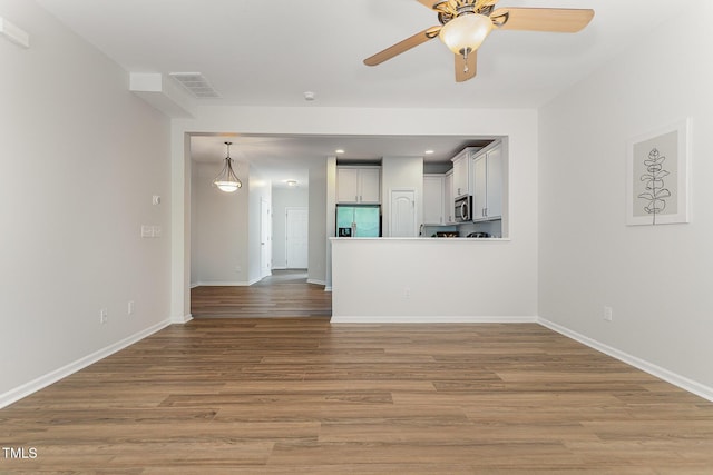 14309 Foxcroft Rd, Raleigh, NC 27614 - unfurnished living room with wood finished floors, a ceiling fan, and recessed lighting