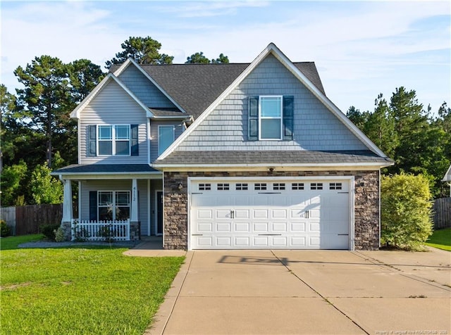 4112 Newgate St, Fayetteville, NC 28306 - craftsman inspired home with stone siding, a porch, driveway, and a garage