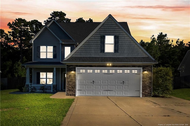 4112 Newgate St, Fayetteville, NC 28306 - craftsman house featuring concrete driveway, stone siding, a porch, and a yard