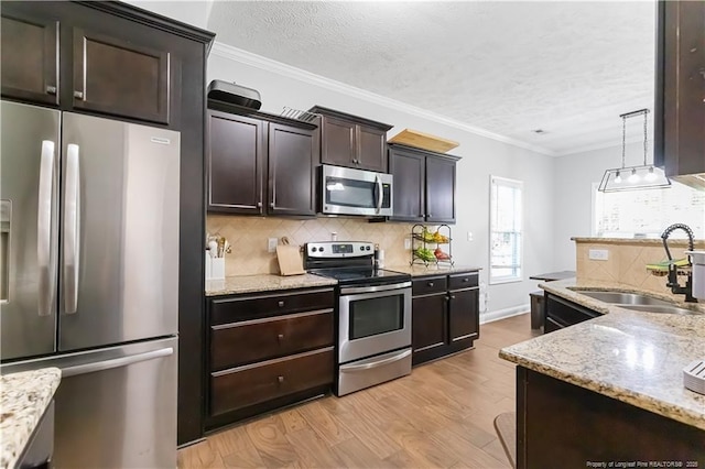 4112 Newgate St, Fayetteville, NC 28306 - kitchen with appliances with stainless steel finishes, decorative backsplash, light wood-type flooring, dark brown cabinets, and a textured ceiling