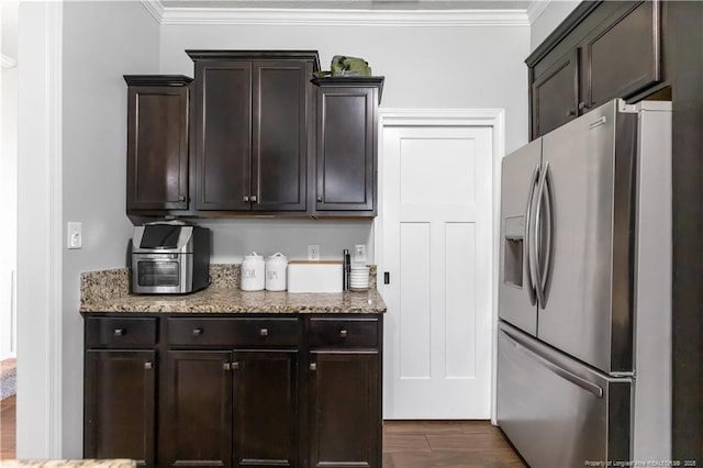 4112 Newgate St, Fayetteville, NC 28306 - kitchen with stainless steel fridge, dark brown cabinetry, crown molding, and light stone countertops