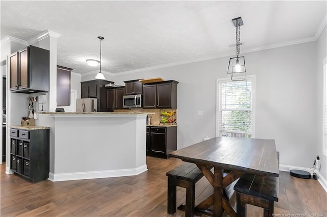 4112 Newgate St, Fayetteville, NC 28306 - kitchen with stainless steel appliances, dark wood finished floors, pendant lighting, ornamental molding, and dark brown cabinets