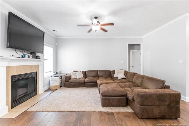 4112 Newgate St, Fayetteville, NC 28306 - living area featuring a tile fireplace, ceiling fan, light wood-type flooring, and ornamental molding