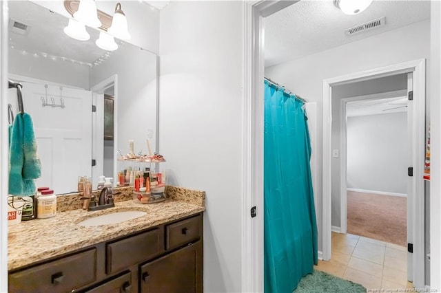 4112 Newgate St, Fayetteville, NC 28306 - full bath featuring vanity, tile patterned flooring, curtained shower, and a textured ceiling