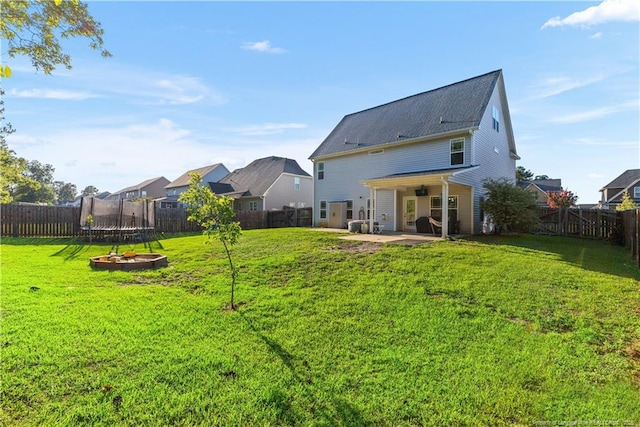 4112 Newgate St, Fayetteville, NC 28306 - back of property with a trampoline, a patio, and a fenced backyard
