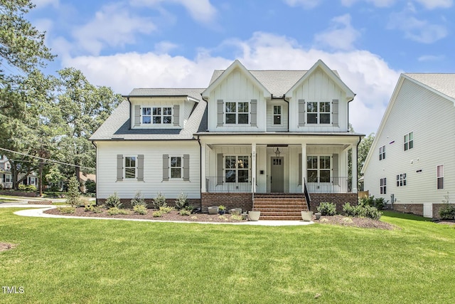 201 S Ennis St, Fuquay Varina, NC 27526 - view of front of house with board and batten siding, covered porch, a front lawn, and roof with shingles
