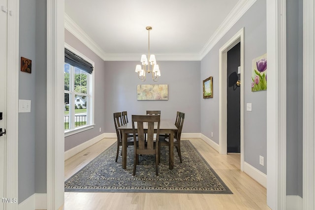 201 S Ennis St, Fuquay Varina, NC 27526 - dining space featuring light wood finished floors, a chandelier, and crown molding