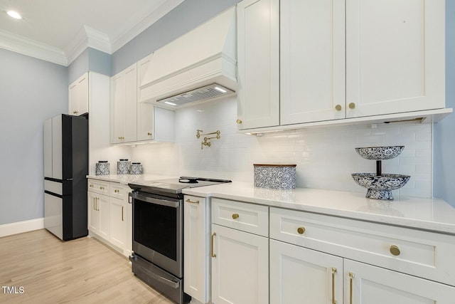 201 S Ennis St, Fuquay Varina, NC 27526 - kitchen featuring electric stove, freestanding refrigerator, custom range hood, crown molding, and backsplash