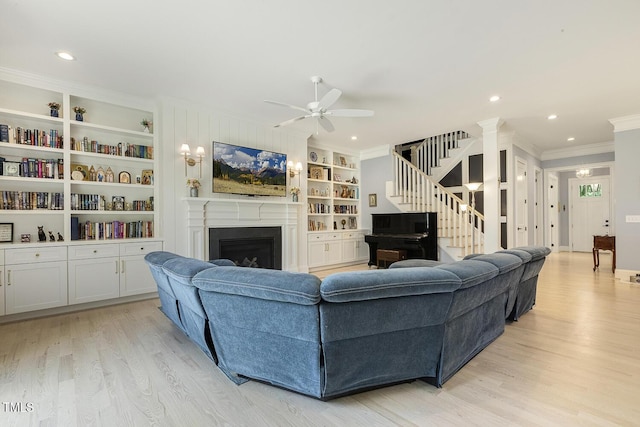 201 S Ennis St, Fuquay Varina, NC 27526 - living area featuring crown molding, light wood-type flooring, ceiling fan, a fireplace, and stairs