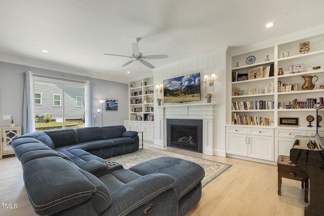 201 S Ennis St, Fuquay Varina, NC 27526 - living room featuring crown molding, light wood-style floors, a ceiling fan, built in shelves, and a fireplace