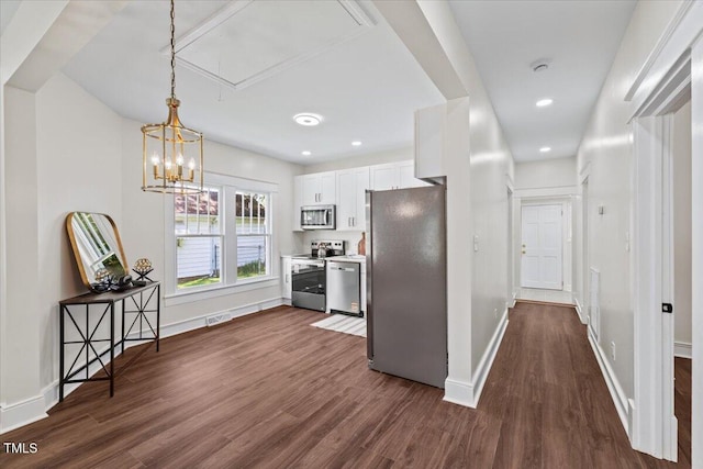 813 N Main St, Burlington, NC 27217 - kitchen with appliances with stainless steel finishes, dark wood-type flooring, white cabinetry, decorative light fixtures, and recessed lighting