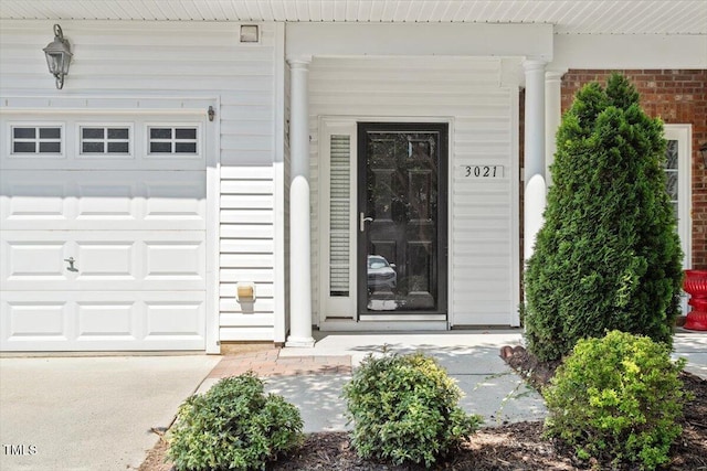 3021 Winding Waters Way, Raleigh, NC 27614 - property entrance with covered porch, brick siding, and an attached garage