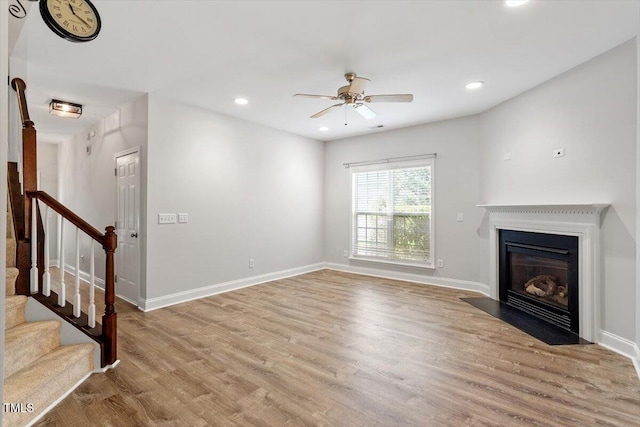 3021 Winding Waters Way, Raleigh, NC 27614 - unfurnished living room featuring a ceiling fan, stairway, wood finished floors, a fireplace with flush hearth, and recessed lighting