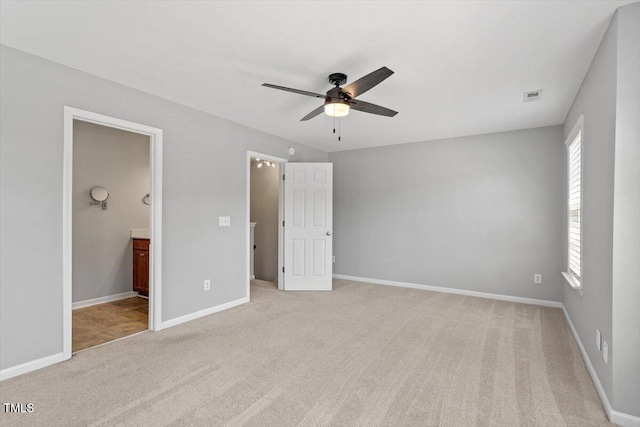 3021 Winding Waters Way, Raleigh, NC 27614 - unfurnished bedroom featuring light colored carpet, ensuite bathroom, and a ceiling fan