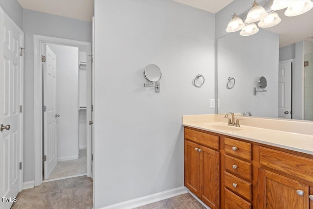 3021 Winding Waters Way, Raleigh, NC 27614 - bathroom featuring vanity, a chandelier, and a spacious closet