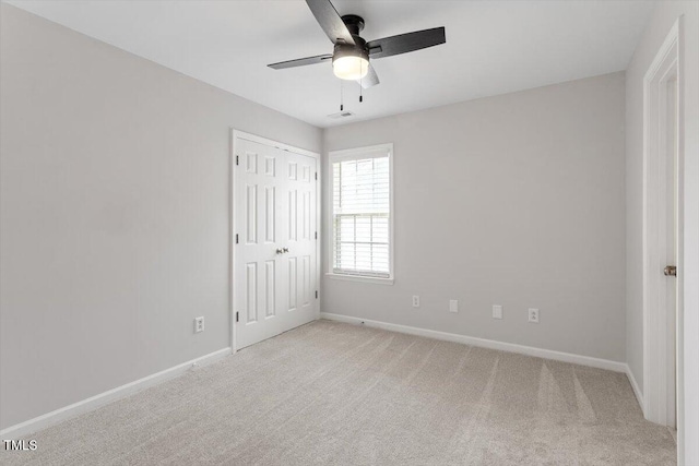 3021 Winding Waters Way, Raleigh, NC 27614 - unfurnished bedroom featuring light carpet, a closet, and a ceiling fan