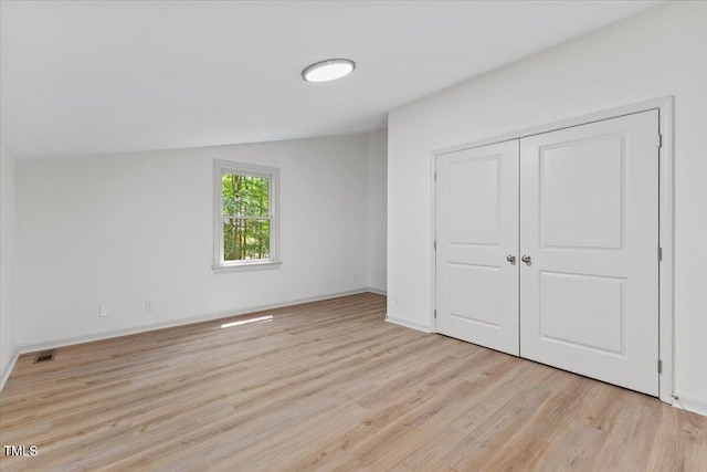 3218 Seven Springs Rd, Hillsborough, NC 27278 - unfurnished bedroom featuring light wood finished floors and a closet