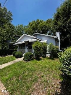 1305 E Jones St, Raleigh, NC 27610 - bungalow featuring a front lawn and a chimney