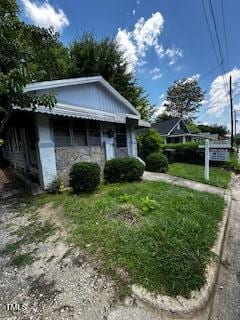 1305 E Jones St, Raleigh, NC 27610 - view of side of property with stone siding and a yard