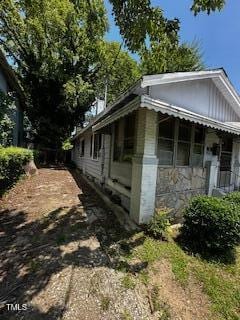 1305 E Jones St, Raleigh, NC 27610 - view of side of home with stone siding