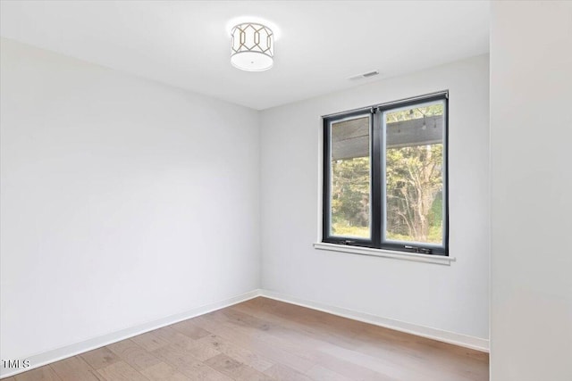1103 S Bloodworth St, Raleigh, NC 27601 - empty room with wood finished floors and baseboards