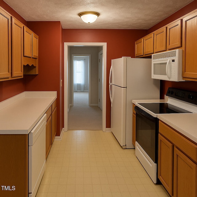 239 Heartwood Dr, Raeford, NC 28376 - kitchen with white appliances, light countertops, a textured ceiling, and light floors