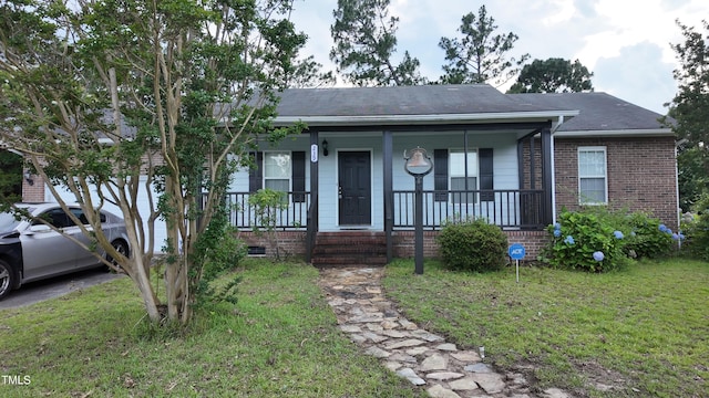 239 Heartwood Dr, Raeford, NC 28376 - single story home featuring a porch, a front yard, and brick siding
