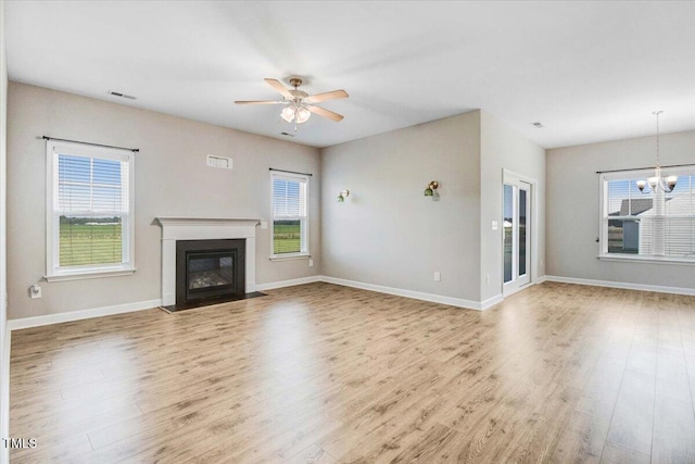 106 Fynloch Chase Dr, Fremont, NC 27830 - unfurnished living room with wood finished floors, a fireplace with flush hearth, healthy amount of natural light, and ceiling fan