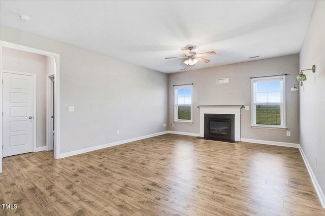 106 Fynloch Chase Dr, Fremont, NC 27830 - unfurnished living room featuring plenty of natural light, a ceiling fan, and wood finished floors