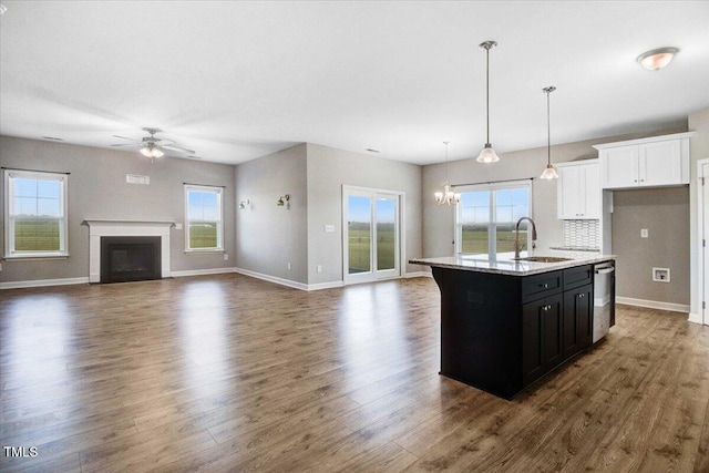 106 Fynloch Chase Dr, Fremont, NC 27830 - kitchen with stainless steel dishwasher, a ceiling fan, dark cabinetry, open floor plan, and an island with sink