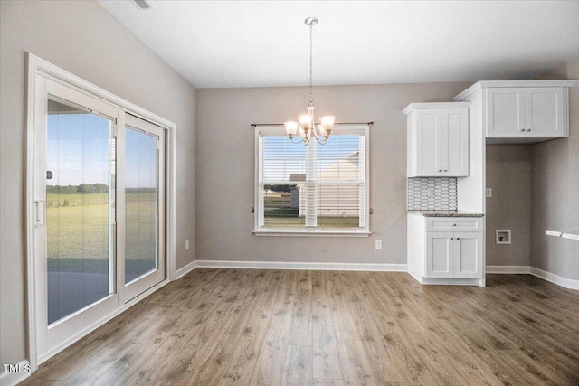 106 Fynloch Chase Dr, Fremont, NC 27830 - unfurnished dining area with light wood-style floors and a chandelier