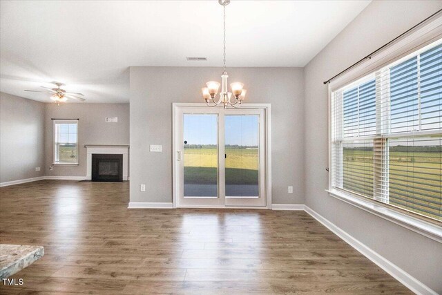 106 Fynloch Chase Dr, Fremont, NC 27830 - unfurnished living room with a chandelier, wood finished floors, a fireplace with flush hearth, and ceiling fan