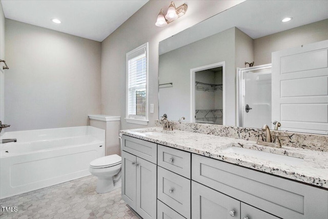 106 Fynloch Chase Dr, Fremont, NC 27830 - full bathroom featuring a shower stall, a bath, double vanity, a walk in closet, and recessed lighting