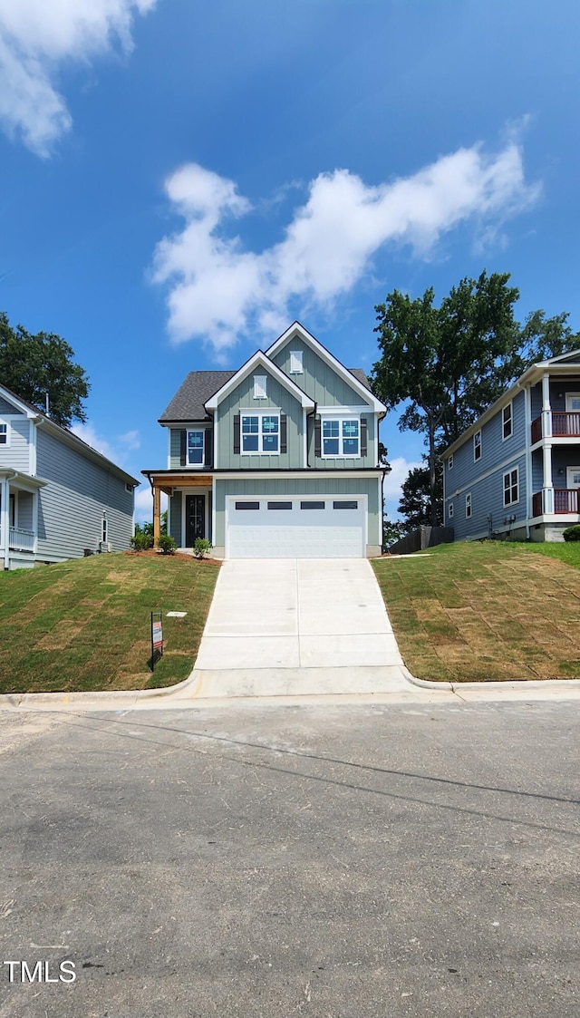 116 Chestnut St, Durham, NC 27707 - craftsman-style home featuring board and batten siding, a garage, concrete driveway, and a front yard