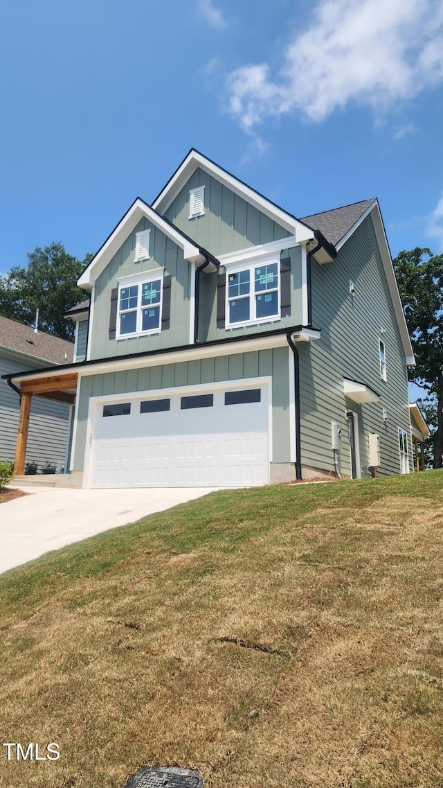 116 Chestnut St, Durham, NC 27707 - craftsman inspired home featuring a garage, concrete driveway, board and batten siding, a front yard, and a shingled roof