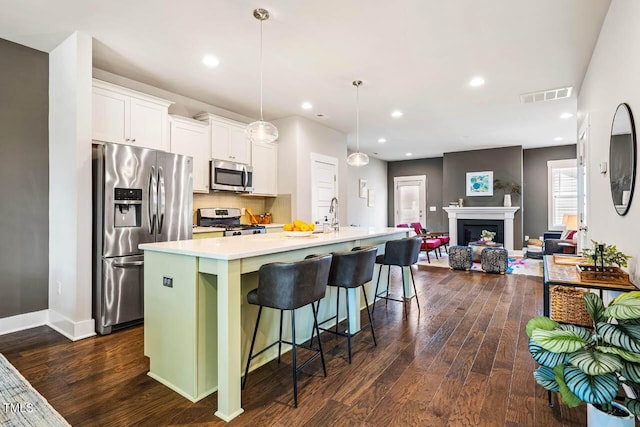 644 Granite Mill Blvd, Chapel Hill, NC 27516 - kitchen with appliances with stainless steel finishes, dark wood-type flooring, light countertops, white cabinets, and recessed lighting