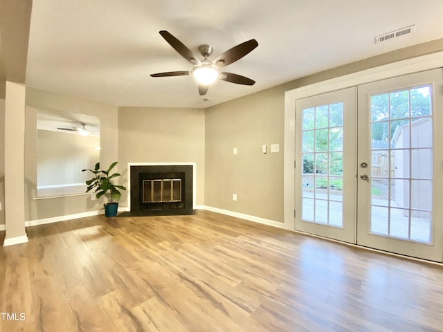 4324 Halliwell Dr, Raleigh, NC 27606 - unfurnished living room featuring french doors, ceiling fan, wood finished floors, and a fireplace with flush hearth