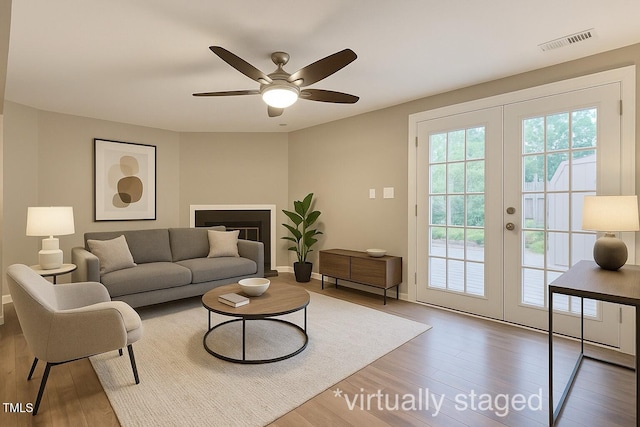4324 Halliwell Dr, Raleigh, NC 27606 - living area featuring french doors, wood finished floors, and a ceiling fan