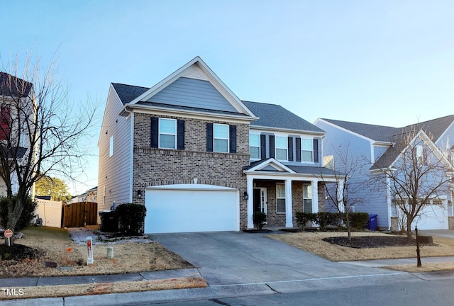302 Glenview Ln, Durham, NC 27703 - view of front of property featuring a garage, concrete driveway, brick siding, a gate, and covered porch