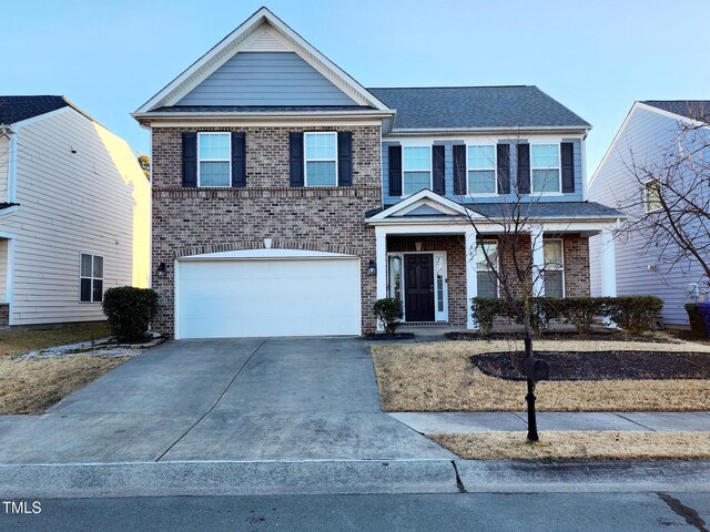302 Glenview Ln, Durham, NC 27703 - view of front facade featuring brick siding, concrete driveway, and an attached garage