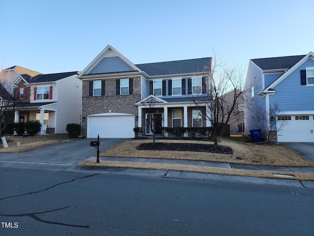 302 Glenview Ln, Durham, NC 27703 - traditional-style house featuring an attached garage, asphalt driveway, and brick siding