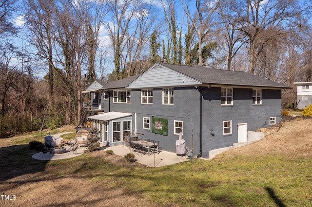 1603 N Alston Ave, Durham, NC 27701 - back of property featuring a patio, brick siding, and a yard