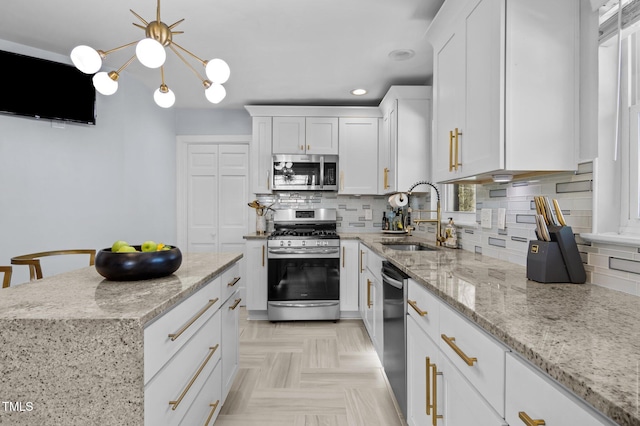 1603 N Alston Ave, Durham, NC 27701 - kitchen with stainless steel appliances, tasteful backsplash, white cabinets, light stone countertops, and pendant lighting