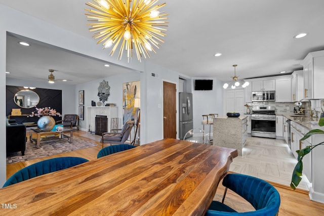 1603 N Alston Ave, Durham, NC 27701 - dining room with recessed lighting, a fireplace, and a chandelier