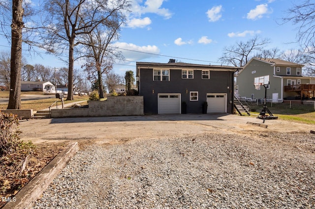 1603 N Alston Ave, Durham, NC 27701 - rear view of house featuring driveway, a garage, and stairs