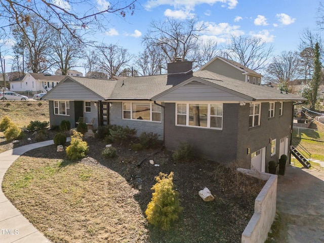 1603 N Alston Ave, Durham, NC 27701 - view of front facade featuring an attached garage, a chimney, stairway, brick siding, and driveway