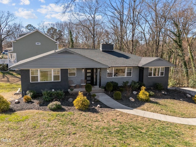 1603 N Alston Ave, Durham, NC 27701 - view of front facade featuring a chimney, a front yard, and brick siding