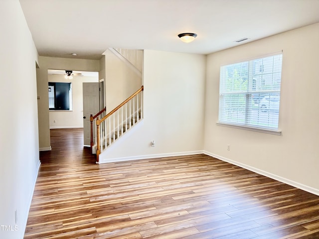 1121 Brookhill Way, Cary, NC 27519 - unfurnished room with stairs, wood finished floors, and a ceiling fan