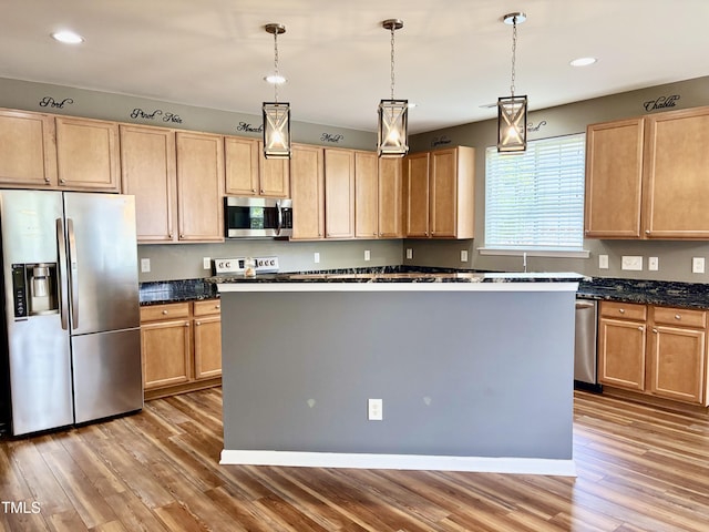 1121 Brookhill Way, Cary, NC 27519 - kitchen featuring appliances with stainless steel finishes, light wood-style floors, a kitchen island, recessed lighting, and decorative light fixtures