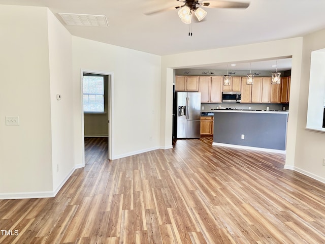 1121 Brookhill Way, Cary, NC 27519 - kitchen featuring appliances with stainless steel finishes, a ceiling fan, and light wood-type flooring